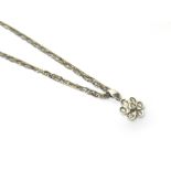 A diamond set seven stone cluster pendant, formed as a stylised flowerhead,