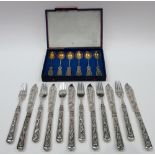 A set of six pairs of Chinese silver fish knives and forks, the handles decorated with dragons,