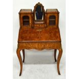 A Victorian marquetry inlaid gilt metal mounted figured walnut lady's writing bureau with fitted