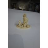 A Japanese ivory group of a kneeling mother and seated child at play, Meiji period, signed, 7.5cm.