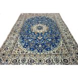 A part silk Nain carpet, Persian, the indigo field with an ivory cartouche medallion,