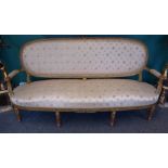 A Louis XVI style gilt wood sofa on tapering fluted supports, 190cm wide x 97cm high.