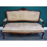 A Louis XV style carved walnut salon suite, the sofa 149cm wide x 110cm high,