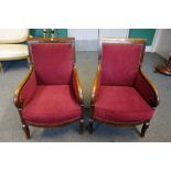 A pair of early 19th century French style mahogany armchairs, on squat sabre supports,