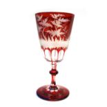 A Bohemian ruby engraved glass part suite of stem ware, early 20th century, decorated with stags,