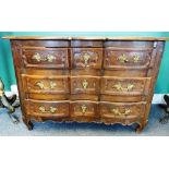 An 18th century French oak commode, with three shaped drawers flanked by rounded corners,