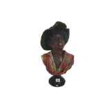 A painted plaster bust of a black boy, l