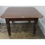 A Victorian mahogany extending dining table, the moulded rectangular top with extra leaf, on turned,