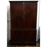 A George III mahogany linen press, the moulded cornice above two pairs of sunk panel doors,