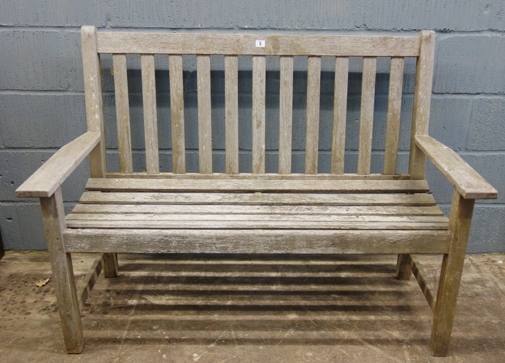 A slatted wooden garden bench seat, 128cm wide.