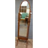 A walnut arched frame cheval mirror in 1