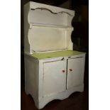 A 20th century miniature painted dresser and an ironing board.