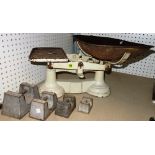 A large set of early 20th century kitchen weighing scales, with weights.