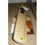 A cricket bat signed by an Old England XI in 2009.