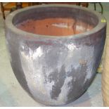 A large grey glazed terracotta plant pot, 54cm wide.