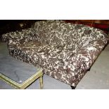A 20th century brown and cream velvet style upholstered two seat sofa,