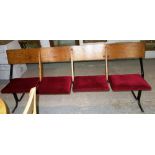 A 20th century bank of four oak and metal theatre seats.