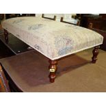 A 20th century mahogany framed rectangular upholstered footstool, 104cm wide.