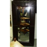 A 20th century brown leather wall mirror, 72cm wide.