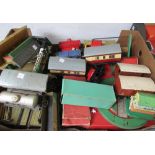 A quantity of Hornby O gauge wagons, coaches, tin buildings, boxed track and accessories (2 boxes).