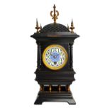 A French mantel clock, late 19th century, the domed carved top with turned finials,