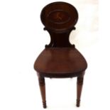 A George III mahogany hall chair, the moulded oval back centred by a painted crest,