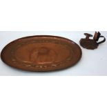 A copper oval tray, probably Newlyn,