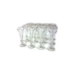 A set of twelve Regency style glass champagne flutes by William Yeoward, facet cut, on knop stems,