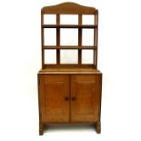 A golden oak and ebony strung cupboard with bookshelves over, by Peter Waals, circa 1930,