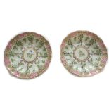 A pair of Royal Worcester shaped circular soup plates, painted with flowers,