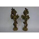 A pair of Art Nouveau gilded and patinated bronzed busts,