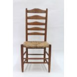 An ash framed ladder back chair with rush seat, 'The Gimson Chair', after a design by Ernest Gimson,