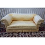A late Victorian drop end Chesterfield settee, upholstered in old gold floral damask,