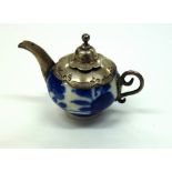 A miniature Dutch Delft blue and white teapot with silver mounts, 5cm across,