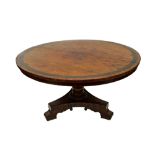 A George IV mahogany breakfast table, the circular tilt-top with a wide black palmwood banding,