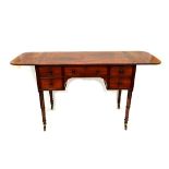A Regency mahogany writing table, the moulded edge top with hinged drop leaves,