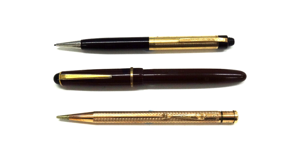 A Sheaffers propelling pencil in black and gilt, stamped 1/10 14k Y.G.F.