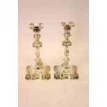 A pair of George II style silver candles