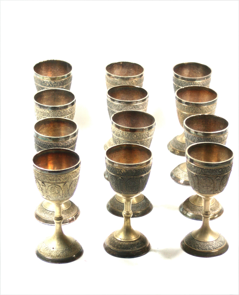 A set of twelve Nepalese plated goblets, 20th century, metalware lined,