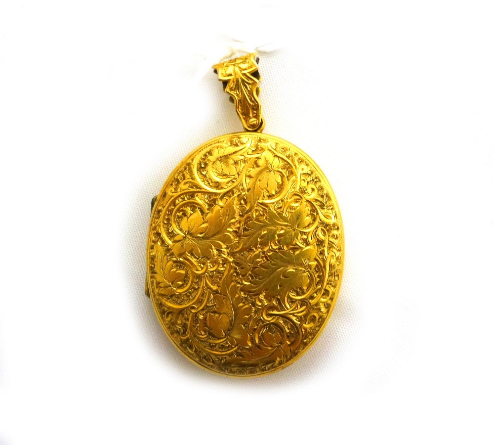 A late Victorian oval locket, profusely