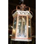 A modern polychrome decorated wrought iron hall lantern of hexagonal form,