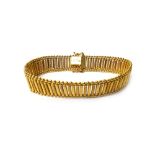 A 9ct gold bracelet, in an alternating decorated and plain bar link design, between beaded sides,