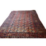 A Tekke turkoman carpet, the madder field with four columns of twelve guls, supporting crosses,