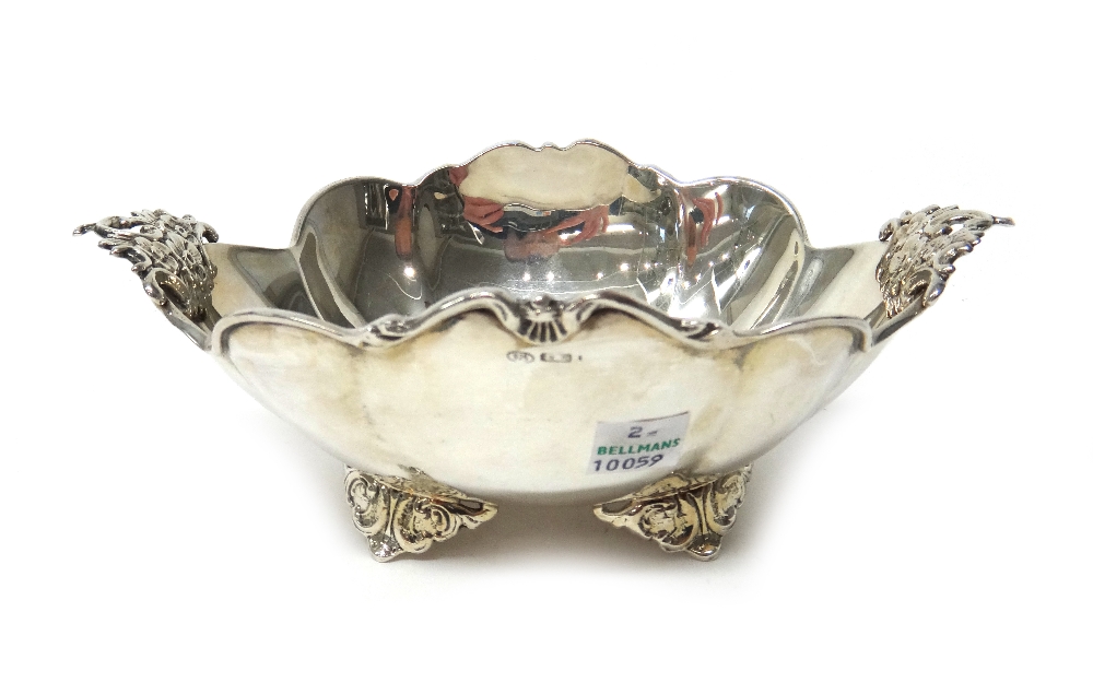 An Italian silver twin handled bowl, of shaped oval form, with floral decoration to the handles,