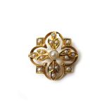 A gold and seed pearl set pendant brooch, in a quatrefoil shaped openwork design, gross weight 3.