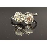 A white gold and platinum, diamond set two stone ring,