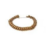 A gold bracelet, in an interwoven multiple link design, detailed 15, fitted with a safety chain,