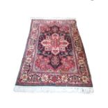 A Mahal rug, Persian, the black field with a bold ivory medallion, madder spandrels,