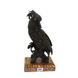 A modern bronzed metal figure of a parrot raised on a faux marble plinth, 35cm high overall.