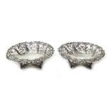 A pair of Victorian silver bonbon dishes, each of oval form, with pierced decoration to the sides,